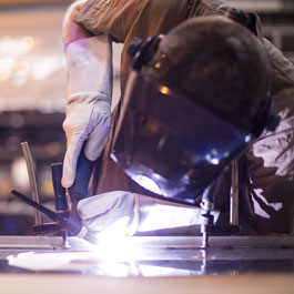 Worker with Protective Mask Welding Metal